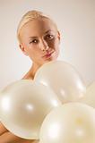 girl with ballons making face