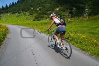 Girl riding fast on bicycle