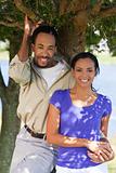 Happy African American Couple Holding Hands Under A Tree