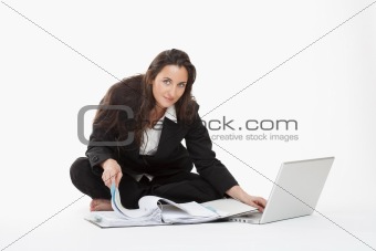 attractive young businesswoman working with laptop computer and files