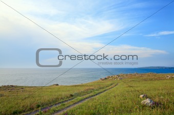 earth road on prairies near summer sea coast