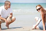 Young loving Couple siting on the beach 