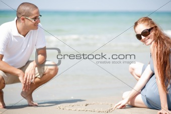 Young loving Couple siting on the beach 