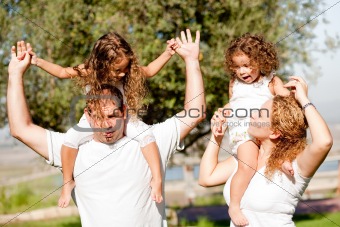 Daughters enjoying their ride on parents shoulders