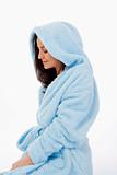 attractive brunette in blue bathrobe with hood isolated on white