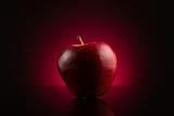 Red apple on dark red background