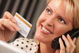 Beautiful Woman on the Phone Holding Her Credit Card.