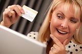 Beautiful Woman on Her Laptop Holding Her Credit Card.