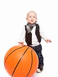 Fashion boy playing whit a huge basketball 