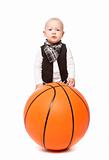 Fashion boy playing whit a huge basketball 