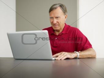 senior using laptop computer