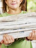 girl recycling newspapers
