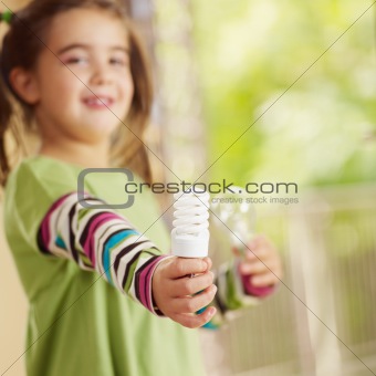 Girl holding light bulb