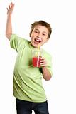 Jumping child holding healthy fruit juice