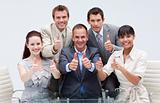 Confident business team with thumbs up