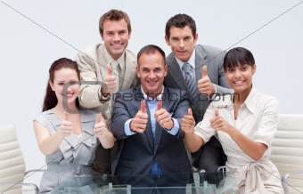 Confident business team with thumbs up