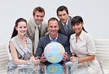 Business team holding a terrestrial globe. Global business