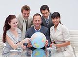 Business team holding a terrestrial globe. Worldwide business