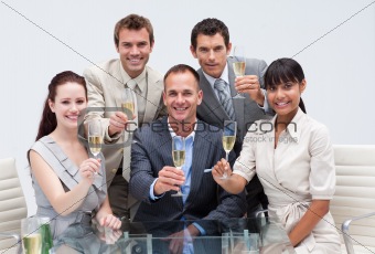 Business team celebrating a success with champagne in the office