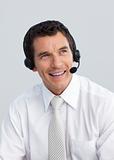 Smiling mature man working in a call center