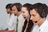 Attractive man with a headset on working in a call center