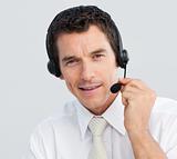 Portrait of an attractive businessman working in a call center