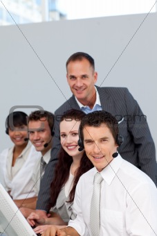 Manager and his team working in a call center