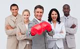 Smiling businessman with boxing gloves leading his team