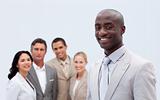 Smiling Afro-American businessman in front of his team