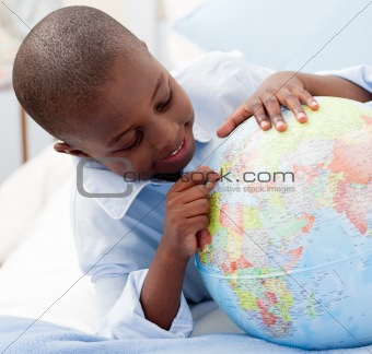 Small boy looking at a Globe