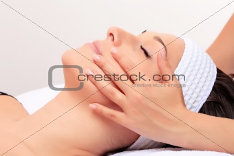 A young woman relaxing at a health spa.