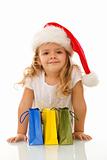 Little girl with christmas hat and shopping bags