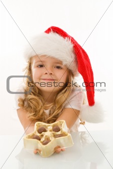 Happy little christmas girl with chocolate