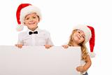Kids with santa hats and white banner for text