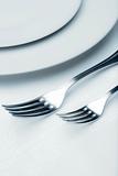 elegant table setting with silverware and plate-closeup of forks