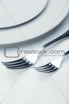 elegant table setting with silverware and plate-closeup of forks