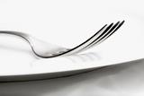 elegant table setting with silverware and plate-closeup of a fork