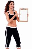 Fitness woman showing a blank clip board