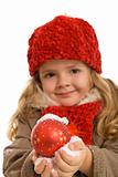 Little girl with warm clothes holding christmas ball