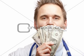 Young happy male doctor kissing us dollar bills