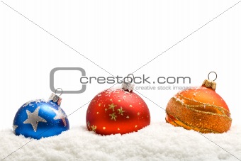 Colorful christmas baubles in the snow