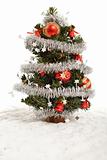 Small decorative christmas tree in artificial snow