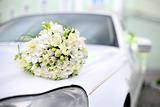 Wedding bouquet lies on the car
