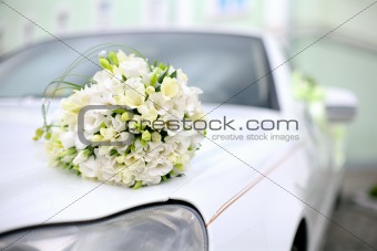 Wedding bouquet lies on the car