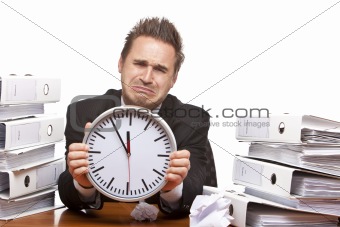 Stressed business man under time pressure cries in office 