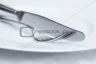 elegant table setting with silverware on white plate