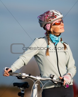 Active young woman with her bicycle
