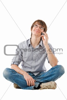 Young man looking dreamy with mobile phone