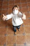 child with pretective mask and thumbs up