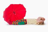 boy with long blond hair playing with a red umbrella